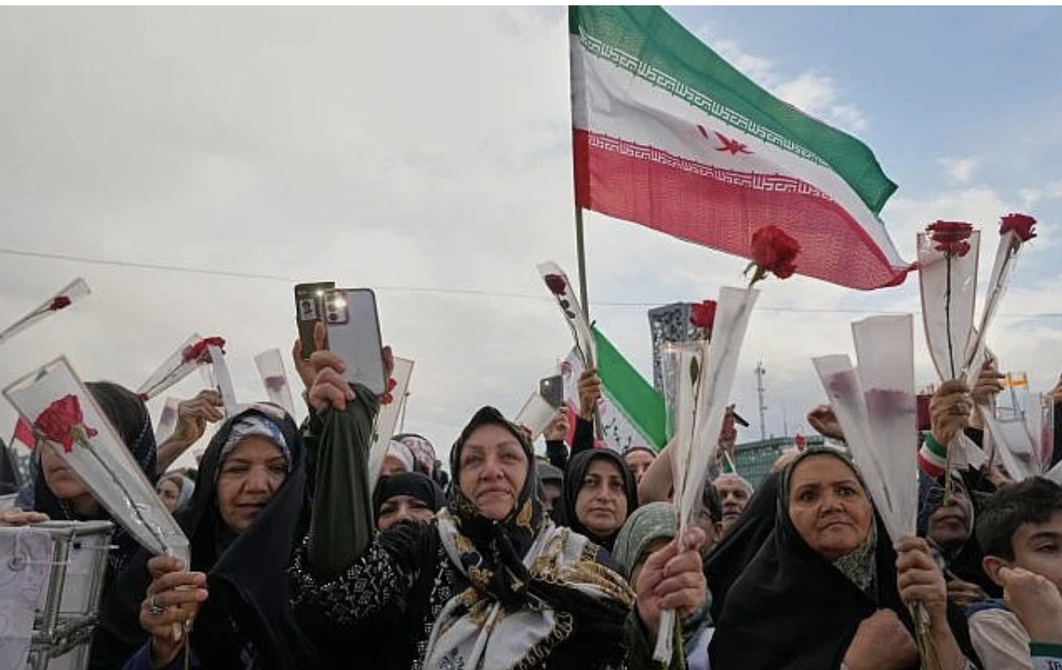 People hold roses as they attend a mass wedding ceremony in Tehran, Iran, May 18, 2026. (AP/Vahid Salemi)
